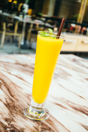 iced Mango juice smoothie glass on table - Color Filter Processingの写真素材