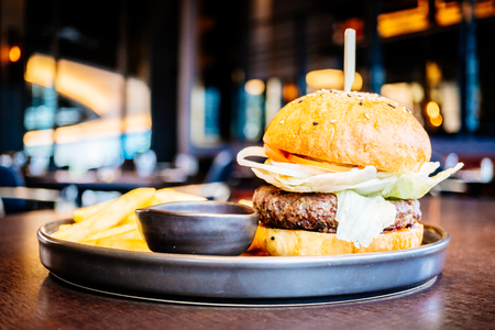 Beef meat hamburger with french fries and tomato sauce - Junk OR Unhealthy food style , Color Filter Processingの写真素材