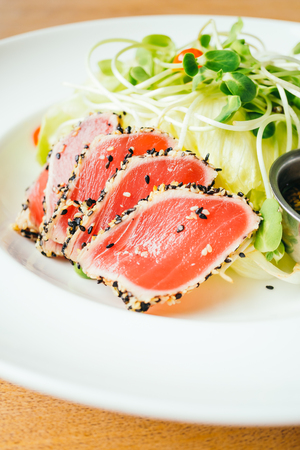 Raw fresh tuna meat with vegetable salad - Vintage light Filterの写真素材