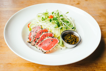 Raw fresh tuna meat with vegetable salad - Vintage light Filterの写真素材