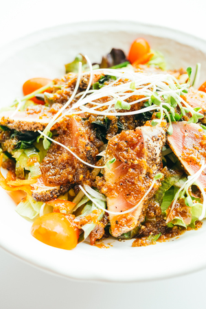 Grilled Raw fresh tuna meat fish with vegetable salad - Japanese food styleの写真素材