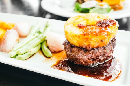 Grilled beef meat steak with vegetable in white plateの写真素材
