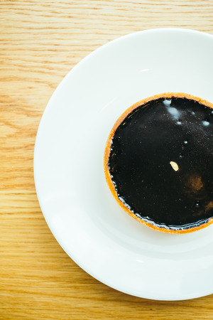 Sweet dessert with chocolate tart in white plateの写真素材