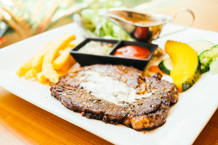 Grilled beef meat steak with vegetable and sauceの写真素材