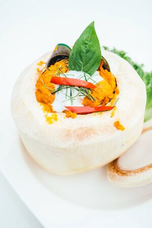 Steamed curry fish and mixed seafood in coconut - Thai food styleの写真素材