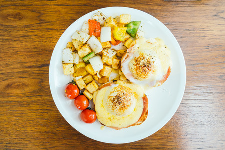 Egg benedict with vegetable for breakfast in white plateの写真素材