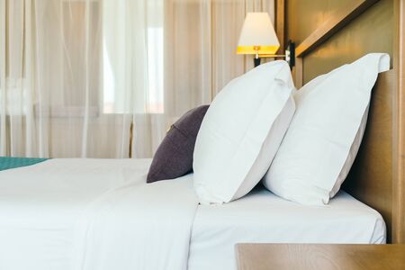 Comfortable pillow on bed decoration bedroom interior with light lampの写真素材