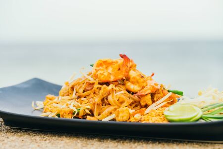 Stir fried noodles with prawn and shrimp in plate or Pad Thaiの写真素材