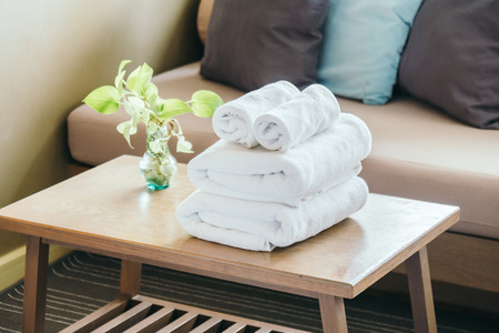 Stack of Towel on table with vase plantの写真素材