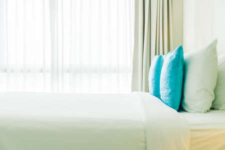 Comfortable pillow on bed decoration bedroom interior with light lampの写真素材