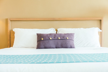 Comfortable pillow on bed decoration bedroom interior with light lampの写真素材