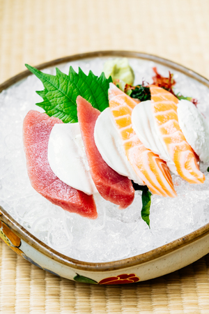 Raw and fresh sashimi set with salmon and tuna fish meat and cheese - Japanese food styleの写真素材