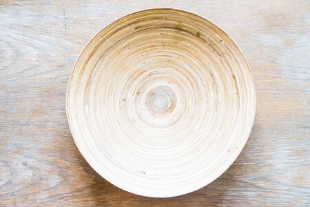 Wooden plate on wood background