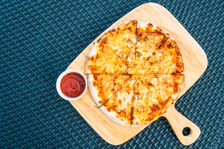 Seafood pizza on wood tray and tomato sauceの写真素材