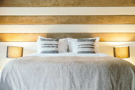 Pillow on bed decoration in bedroom interior with light lamp - Filter Processingの写真素材