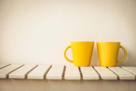 Yellow coffee cup on table with copy spaceの写真素材