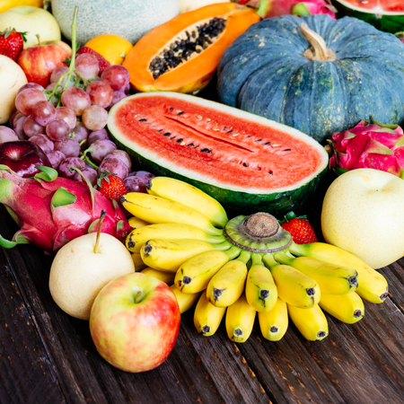 Assorted and mixed fruits on wooden background with copy space - Healthy food conceptの写真素材