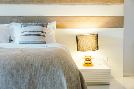 Pillow on bed decoration in bedroom interior with light lamp - Filter Processingの写真素材