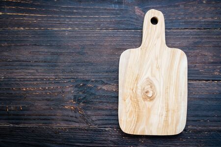 Wood cutting board on wooden background with copy spaceの写真素材