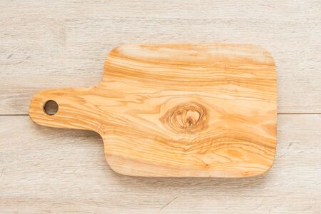 Wood cutting board on wooden background with copy space