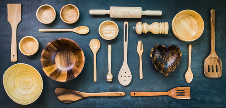 Kitchen utensils with copy space on black stone background