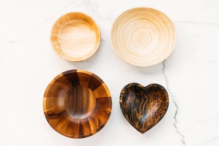 Wood bowl on white marble stone backgroundの写真素材