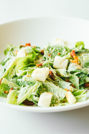 Grilled caesar salad with fresh vegetable in white plate - Healthy food styleの写真素材