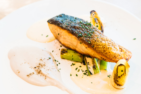 Salmon fillet meat steak with sauce in white plate - Healthy food styleの写真素材