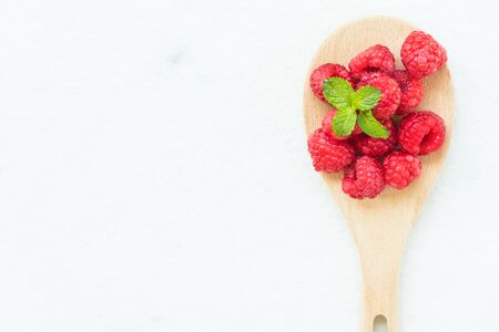 Red rasberries fruit in spoon on tableの写真素材