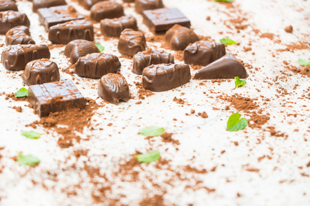Sweet dessert with dark chocolate pieces and cocoa powder on white stone backgroundの写真素材