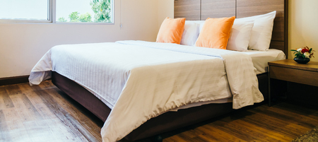 Comfortable pillow on bed decoration interior of hotel roomの写真素材