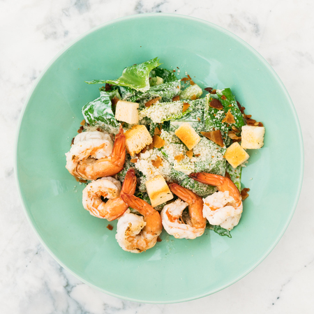 Caesar salad with shrimp or prawn in plate - Healthy food styleの写真素材