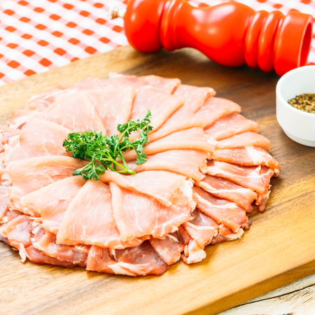 Raw pork meat slice on wood cutting board - FIlter Processingの写真素材