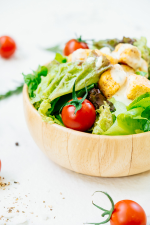 Clean and healthy food style with Caesar salad in wooden bowlの写真素材