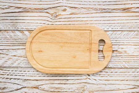 Wood cutting board on wooden background with copy spaceの写真素材