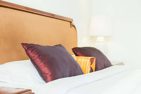 Comfortable pillow on bed decoration interior of hotel roomの写真素材