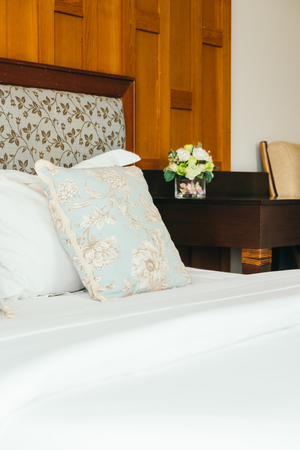 Comfort pillow on bed with light lamp decoration in hotel bedroom interiorの写真素材