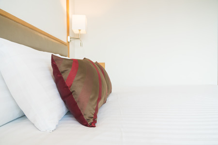 Comfortable pillow on bed decoration in bedroom interiorの写真素材