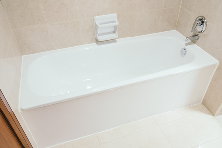 White bathtub decoration in bathroom interior