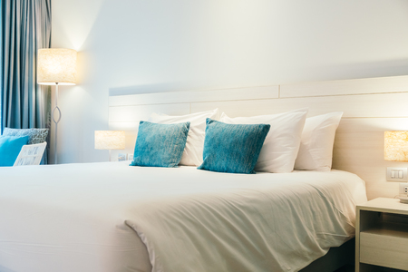 Comfortable pillow on bed decoration in hotel bedroom interiorの写真素材