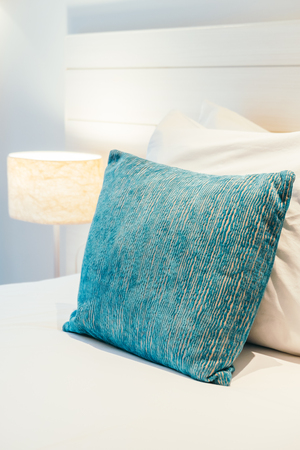 Comfortable pillow on bed decoration in hotel bedroom interiorの写真素材