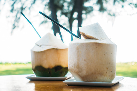 Coconut fruit and juice on tableの写真素材
