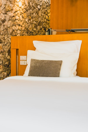 Confortable white pillow on bed decoration interior of bedroomの写真素材