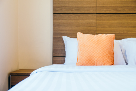 Comfortable pillow on bed decoration interior of hotel roomの写真素材