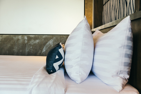 Comfortable pillow on bed decoration in hotel bedroom interiorの写真素材