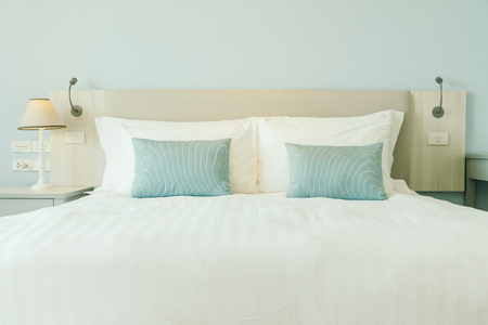 Comfortable pillow on bed decoration in hotel bedroom interiorの写真素材