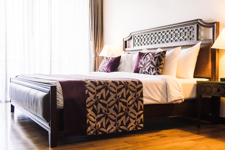 Comfortable pillow on bed decoration in hotel bedroom interiorの写真素材