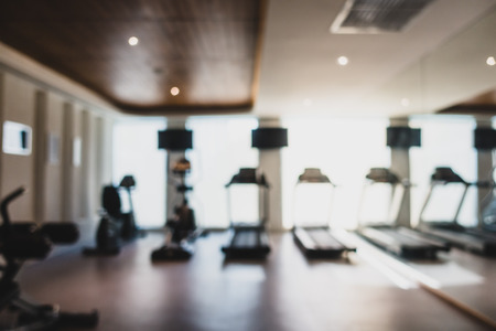 Abstract blur and defocused fitness equipment in gym interior for backgroundの写真素材