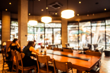 Abstract blur defocused coffee shop cafe and restaurant interior for backgroundの写真素材