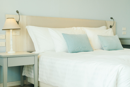 Comfortable pillow on bed decoration in hotel bedroom interiorの写真素材